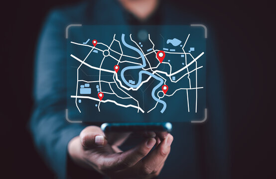 Businessman using smartphone searching world map with location point, GPS app, Destination travel maps and find places in the online system, searching by satellite system. - Powered by Adobe