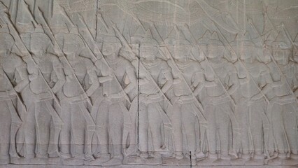Angkor Wat, Cambodia - 3 July 2025. Stone carving of uniformed spear-bearing soldiers in formation,...