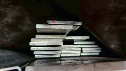 Close-up of rectangular hollow steel sections showing smooth metal surfaces, ready for use in architectural and engineering applications.