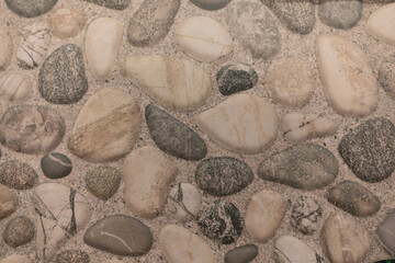 Natural stones arranged in a decorative pattern for flooring or wall design in a modern home setting