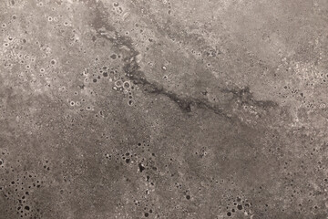 Textured surface showing intricate patterns of a gray material, ideal for interior design and construction projects