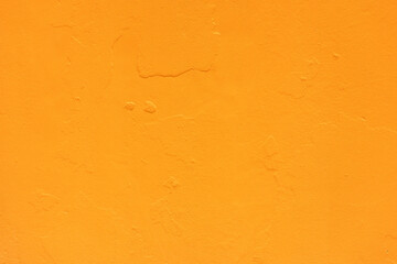 Bright orange wall offers a cheerful backdrop for urban art and inspiration