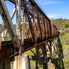 Rusted railroad bridge spanning a valley