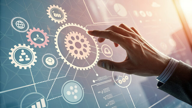 A hand interacting with a digital interface displaying interconnected gears and data visuals - Powered by Adobe