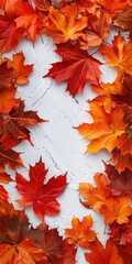 Vibrant autumn leaves in shades of red and orange arranged on a textured white background, creating a seasonal atmosphere and inviting visual appeal for fall-themed projects