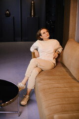 Woman Sitting Cross Legged On Sofa