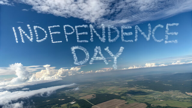 Independence day cloud writing over landscape aerial view with blue sky and scattered clouds above