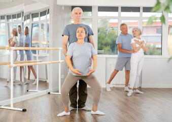 Elderly couples learning to dance ballet in a dance studio