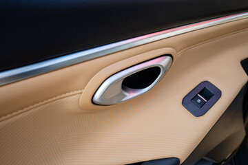 The design of the sleek interior car door handle and control panel is a perfect fusion of comfort...