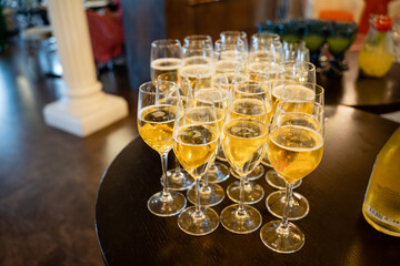 An elegant and beautifully arranged lineup of glasses filled with a sparkling and refreshing beverage, perfect for enhancing celebratory events and gatherings that bring people together in joy