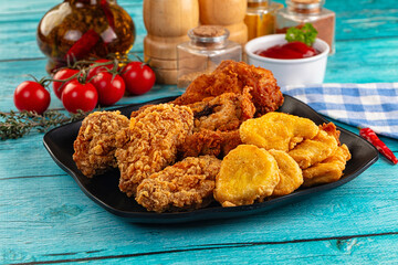 Golden crispy fried chicken mix - wings, drumsticks, nuggets and strips