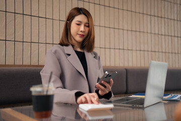 Businesswoman calculates financials with graph paper on the table on the cost.