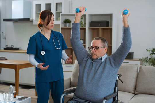 senior man doing exercise at clinic with physiotherapist. help of a therapist trainer during a rehabilitation session.