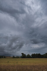 
WEATHER - Dramatic rain clouds over fields and wind farm