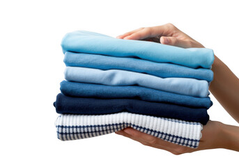 Hands carefully holding a neat stack of folded blue and white clothing items isolated on transparent background