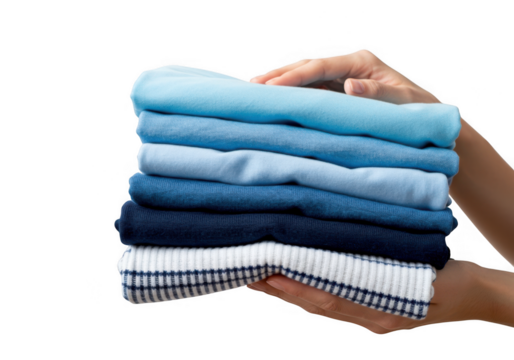 Hands carefully holding a neat stack of folded blue and white clothing items isolated on transparent background