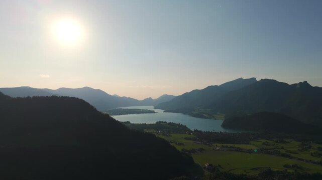 Aerial static fly pristine lake under sunlight landscape, Alps in Late Afternoon Light, Drone fly in Austria, Wolfgangsee waters
