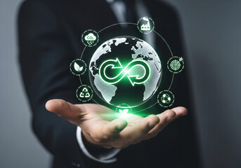 Businessman showcases circular economy concept with global sustainability icons representing reuse and recycling for a greener future.