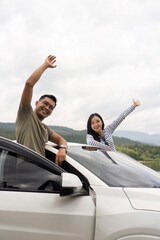 Couple enjoying the view from their car