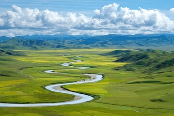 Winding river through a vibrant valley under a vast sky