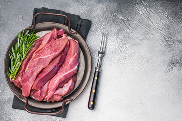 Slices of duck breast fillet, raw fresh poultry meat. grey background. top view