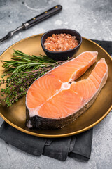 Juicy raw salmon cut, highlighting its natural marbling and freshness. Perfect for grilling or baking to create a mouthwatering meal. grey background. top view