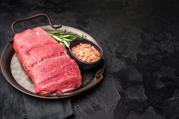 A selection of raw bison steaks arranged artfully, emphasizing their quality and texture, inviting culinary creativity in the kitchen. black background. top view