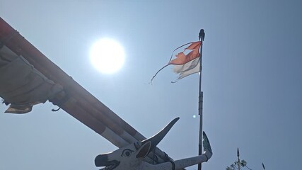 A striking video featuring a torn Indonesian flag fluttering on a weathered boat, set against a dynamic sea backdrop, creating a poignant and textured background for artistic or storytelling projects.