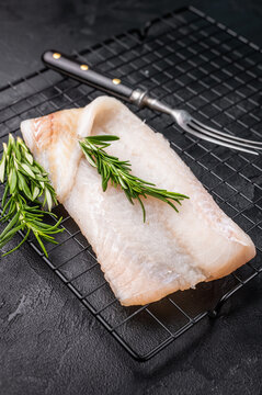 Uncooked Atlantic cod fillet, raw fish ready to be seasoned and transformed into a delicious meal. black background. top view