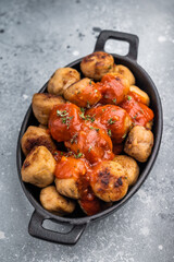 Roast meatballs served with tomato sauce. A classic comfort food in a skillet. grey background. top view