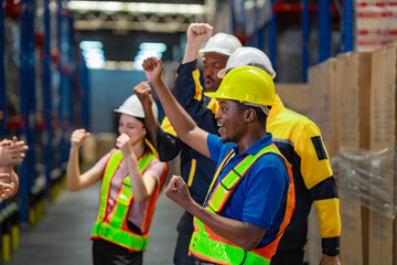 Team members raise arms and dance in a joyful group moment, celebrating their hard work and shared success in logistics.