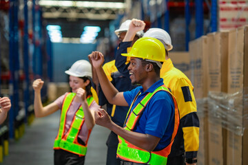 Celebrating employees dance in high spirits inside a warehouse. Great visual for positive work culture and team achievement.