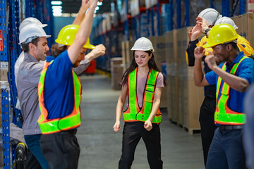 Logistics workers cheer and raise their arms, dancing with excitement after a job well done. A great image of team spirit and productivity.