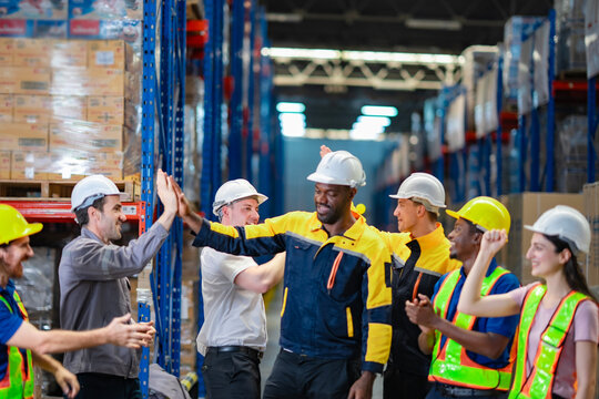 Workers from various cultural backgrounds bonding in the warehouse. Ideal for diversity hiring campaigns and workplace collaboration visuals. - Powered by Adobe