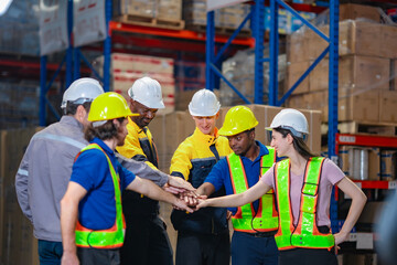 Inspired team of employees demonstrates support and collaboration with stacked hands. Great for company branding, human resources, or promoting cooperative work values in industry.