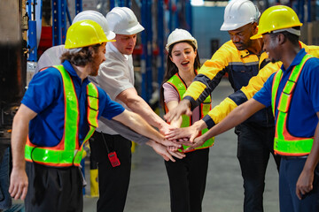 Dedicated logistics staff symbolizing team harmony through hand stacking. Represents corporate unity, shared goals, and organizational culture in a productive, modern warehouse.
