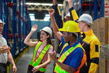 Female warehouse worker receives a round of applause from her team, smiling with pride after being recognized for her outstanding performance or promotion.