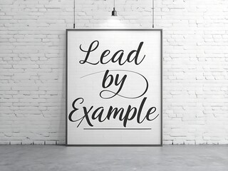 Inspiring lead by example quote displayed in a framed poster against a white brick wall