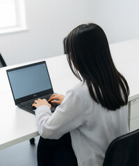 young woman working on laptop