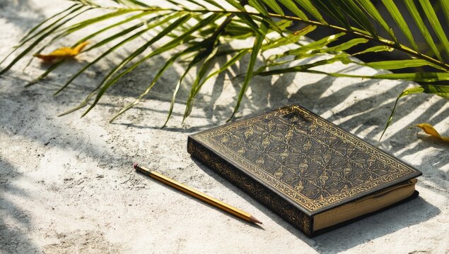 Ornate journal on textured surface, palm fronds