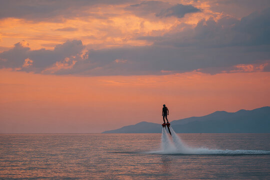 experience thrill of flyboarding at sunset where athlete performs extraordinary stunt