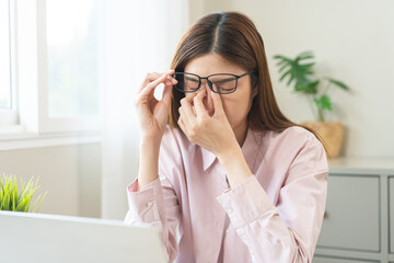 Eye problem concept, fatigue asian young woman tired eyes, irritated rubbing nose, relief vision...