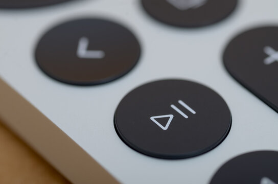 Close-Up of Play/Pause Button on Modern Device with Shallow Depth of Field