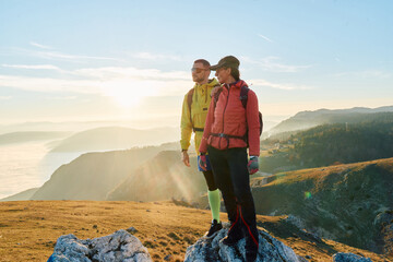 Couple in Love Enjoying the View at the Top of a Mountain.