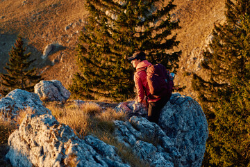 A female mountaineer, equipped with professional gear, enjoys the thrill of her climb as she...