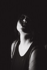 Sensual portrait of a woman with dark hair, done in a low key style.