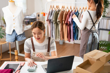Online Store Inventory Manager Using Laptop Computer, Preparing a Small Parcel for Postage. Young...