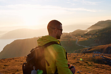 An extreme mountaineer, equipped with professional gear, pushes towards the peak of the mountain at...
