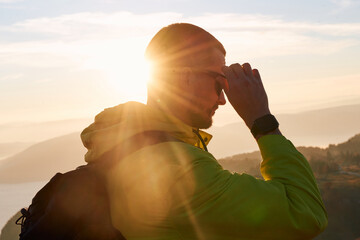 An extreme mountaineer, equipped with professional gear, pushes towards the peak of the mountain at...