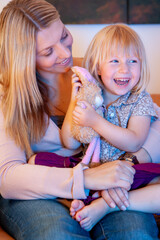 Family Life, Mother and Daughter. A candid moment of bonding between a parent and her child. From a series of related images.